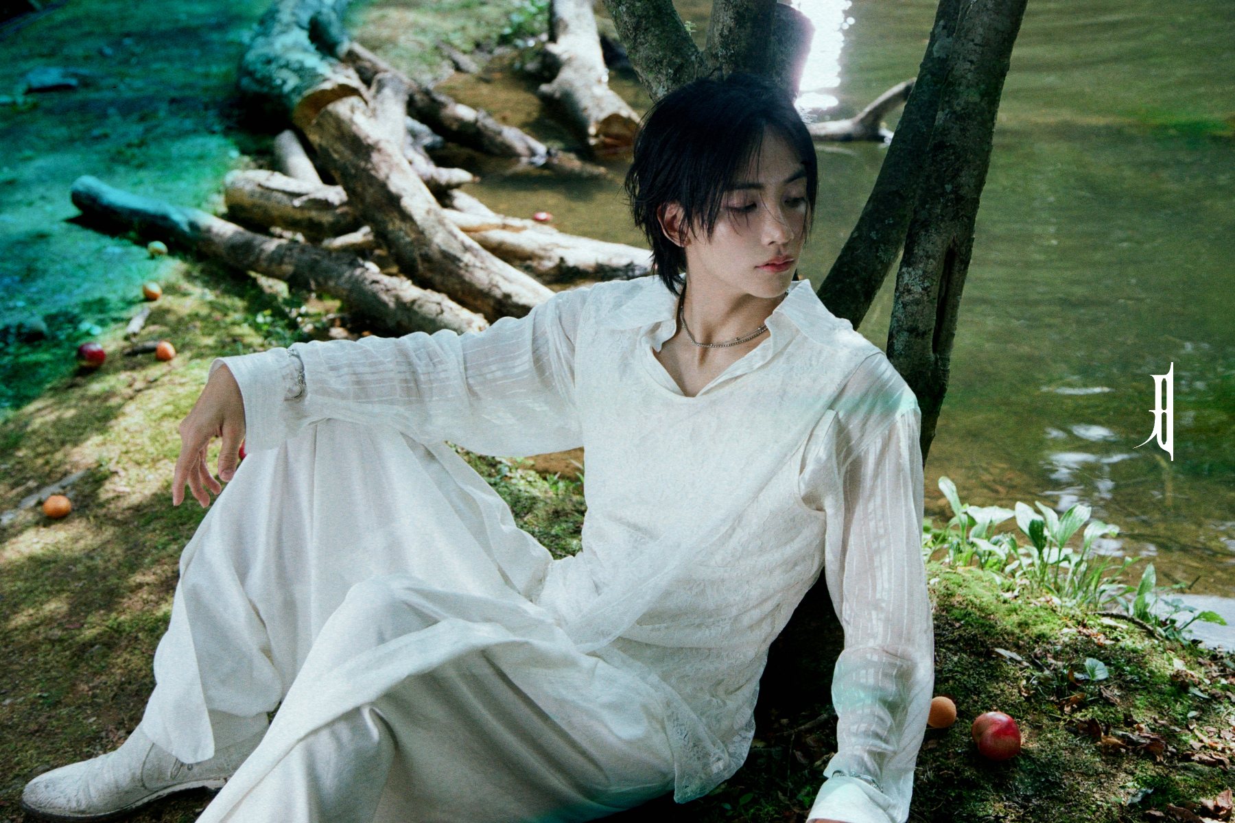 Jeonghan sitting against tree for 'DREAMSCAPE' promotional material.